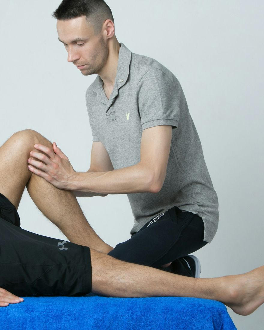 A physiotherapist assessing a client's knee